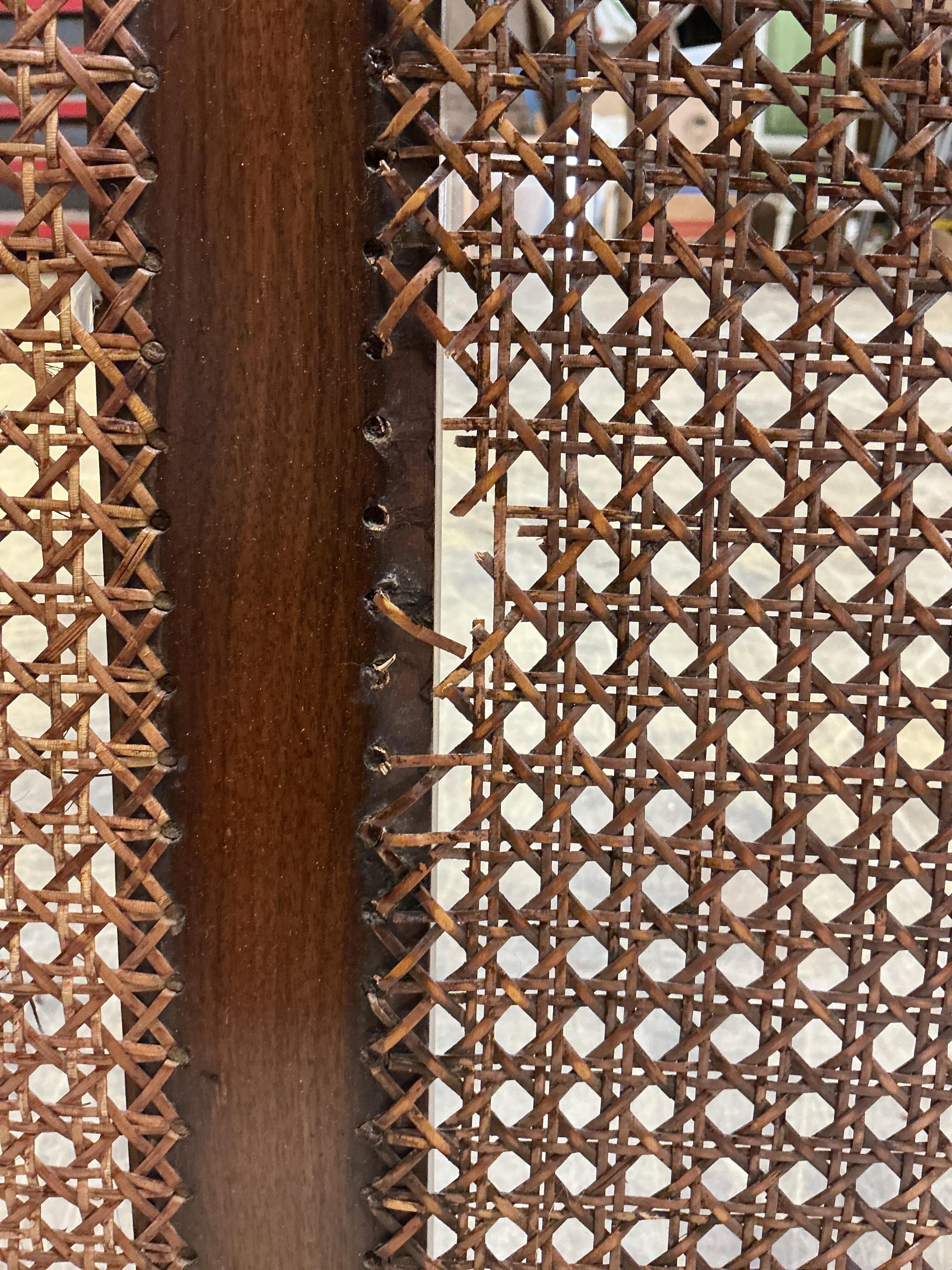An early 20th century mahogany three piece bergere suite